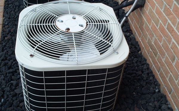 Outdoor condenser unit with the coil and fan guard visible